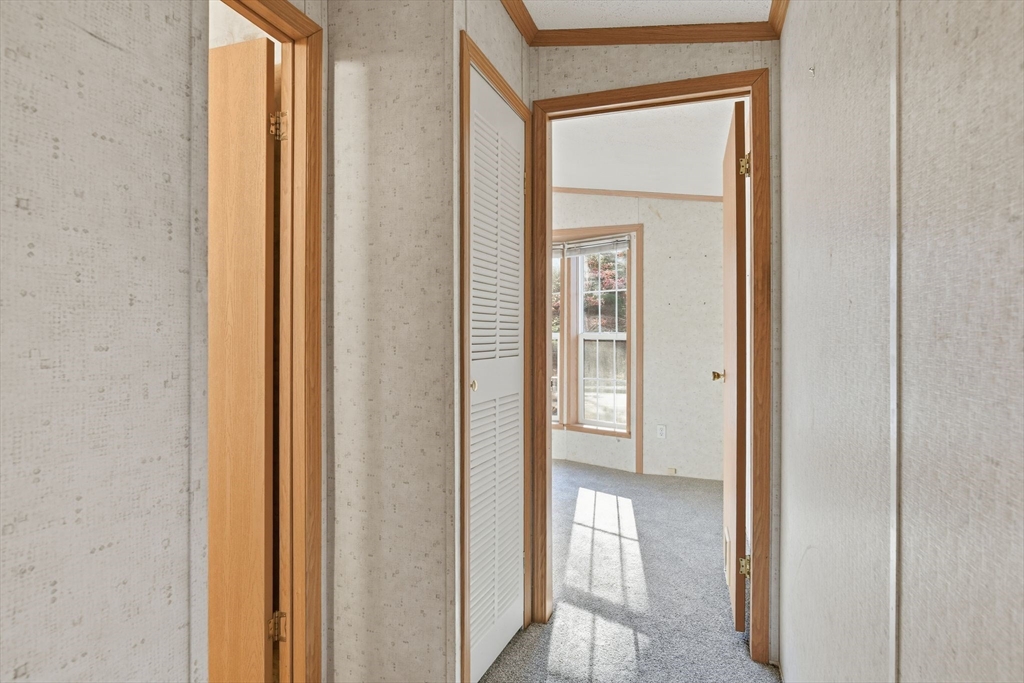 15 Quaboag Valley, Unit 15 Sudbury, MA 01776 - Photo 23 of 35 a view of a bathroom from a corridor
