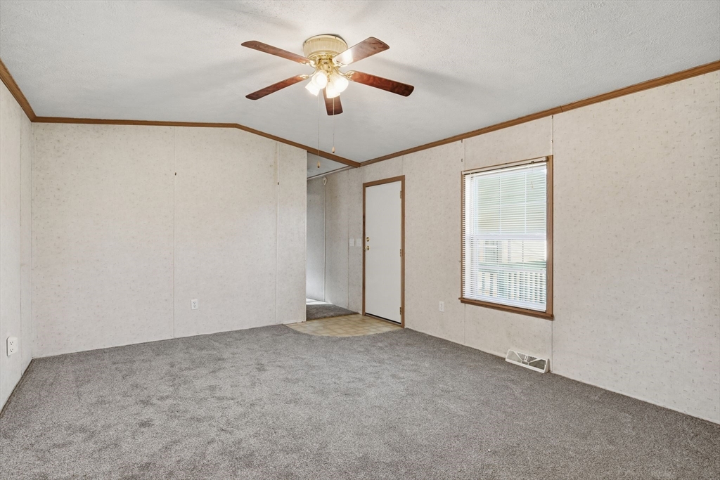 15 Quaboag Valley, Unit 15 Sudbury, MA 01776 - Photo 5 of 35 an empty room with windows and fan