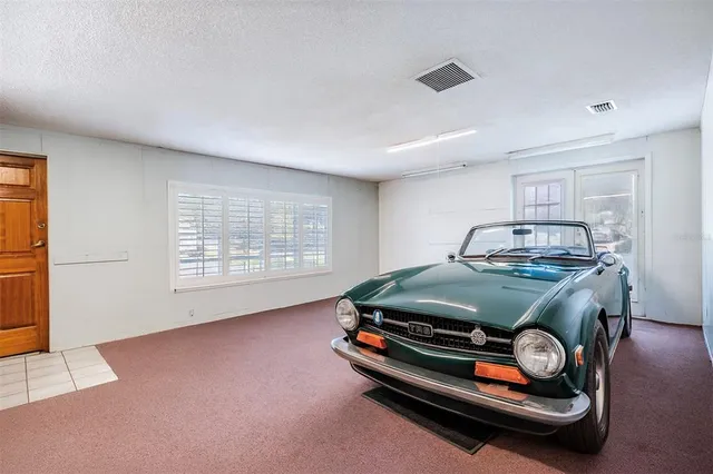 a front view of a house with a yard and a garden