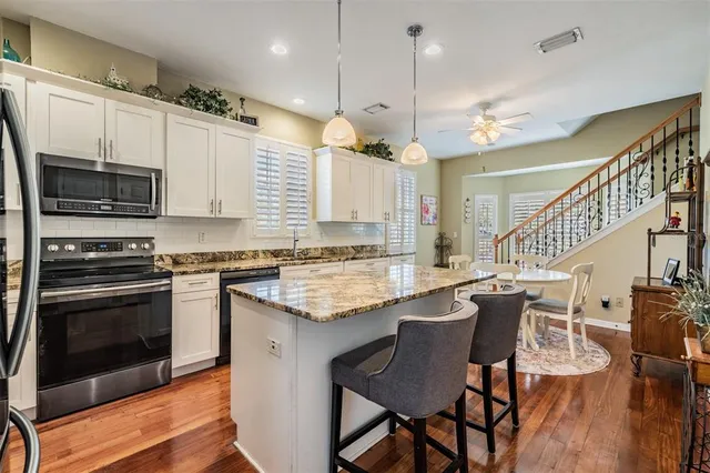 a large kitchen with a table and chairs