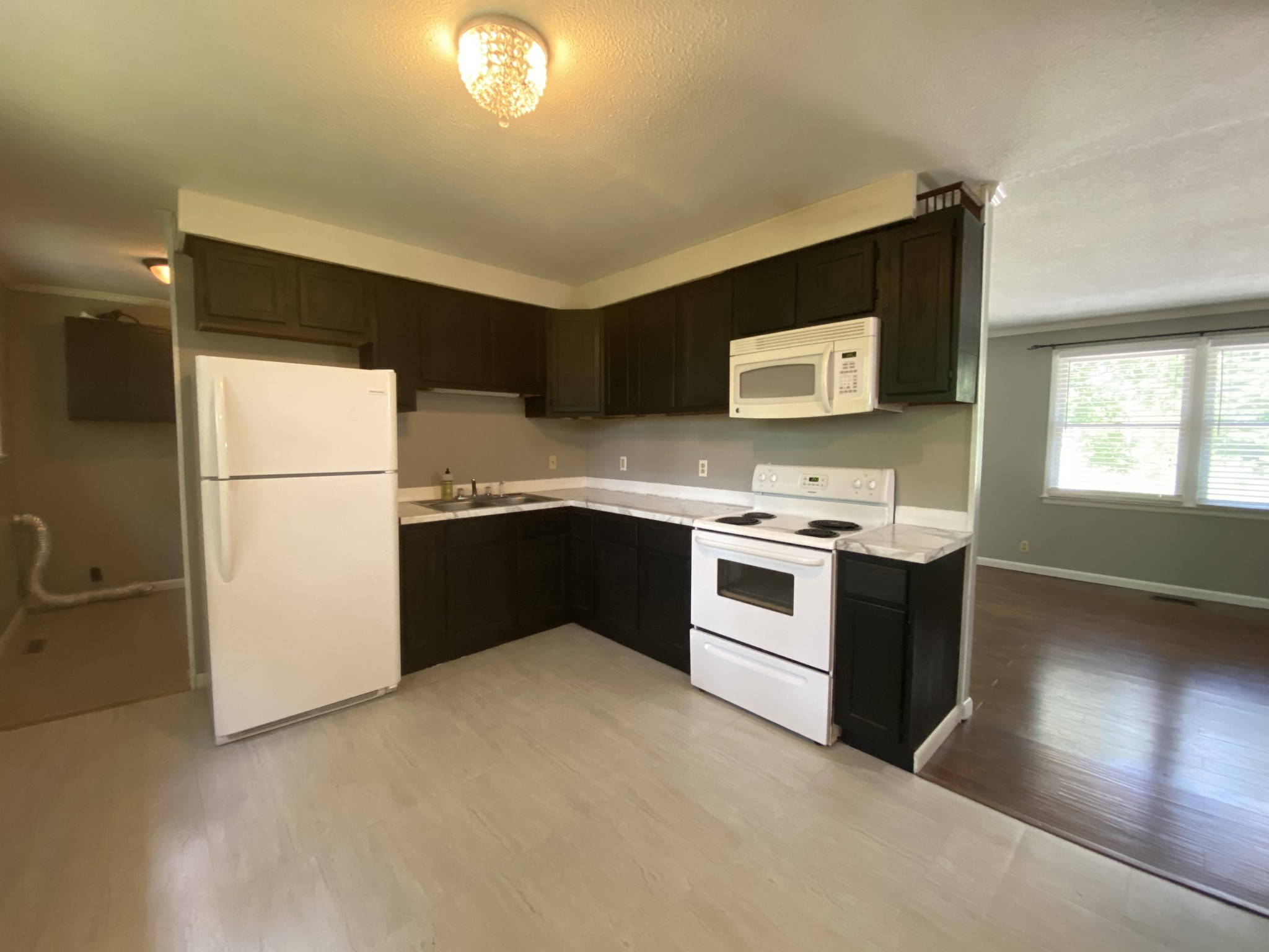 1320 Gratton Road Clarksville, TN 37043 - Photo 8 of 14 a kitchen with stainless steel appliances a refrigerator sink and white cabinets
