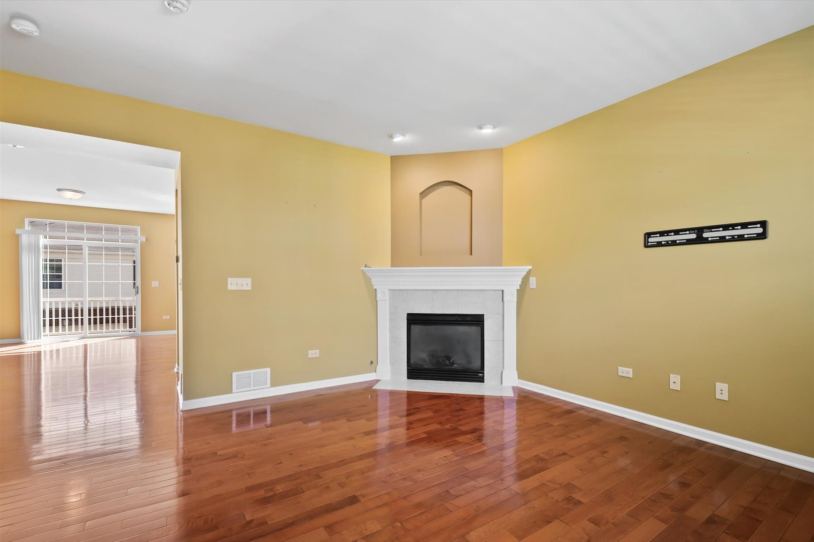 1908 Oxley Circle Naperville, IL 60563 - Photo 6 of 27 a view of empty room with wooden floor and fireplace