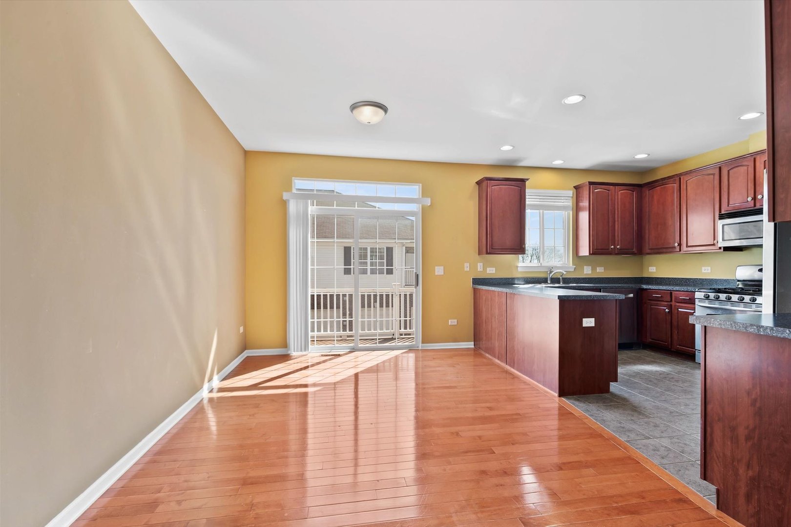 1908 Oxley Circle Naperville, IL 60563 - Photo 7 of 27 a large kitchen with stainless steel appliances granite countertop a granite counter tops and a window