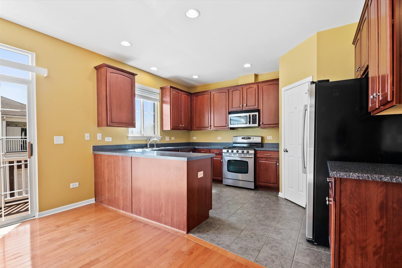 1908 Oxley Circle Naperville, IL 60563 - Photo 8 of 27 a kitchen with stainless steel appliances granite countertop a refrigerator stove top oven and sink