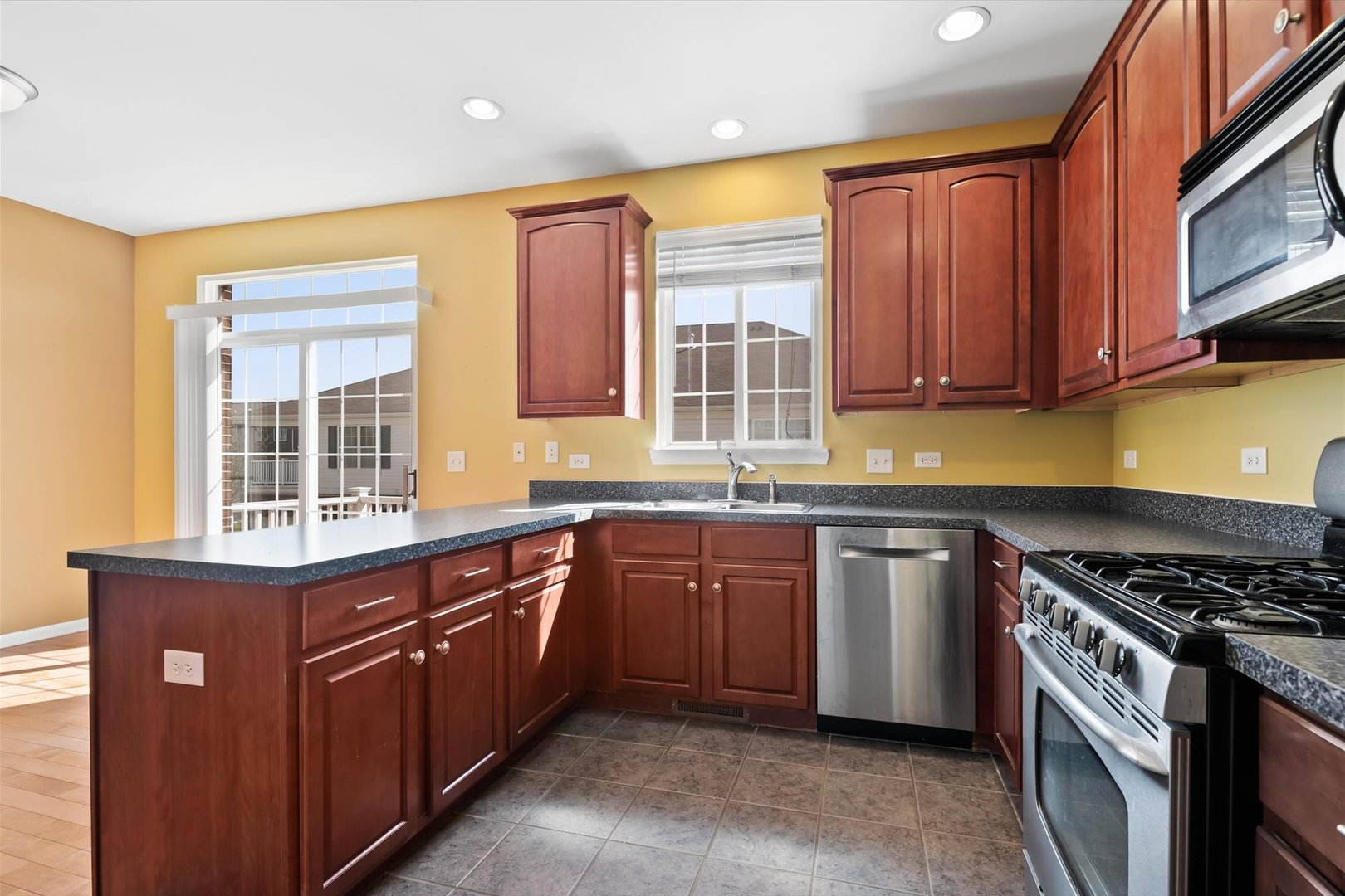1908 Oxley Circle Naperville, IL 60563 - Photo 9 of 27 a kitchen with stainless steel appliances granite countertop a stove a sink and a microwave