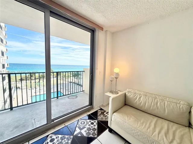 a large white kitchen with a sink and refrigerator