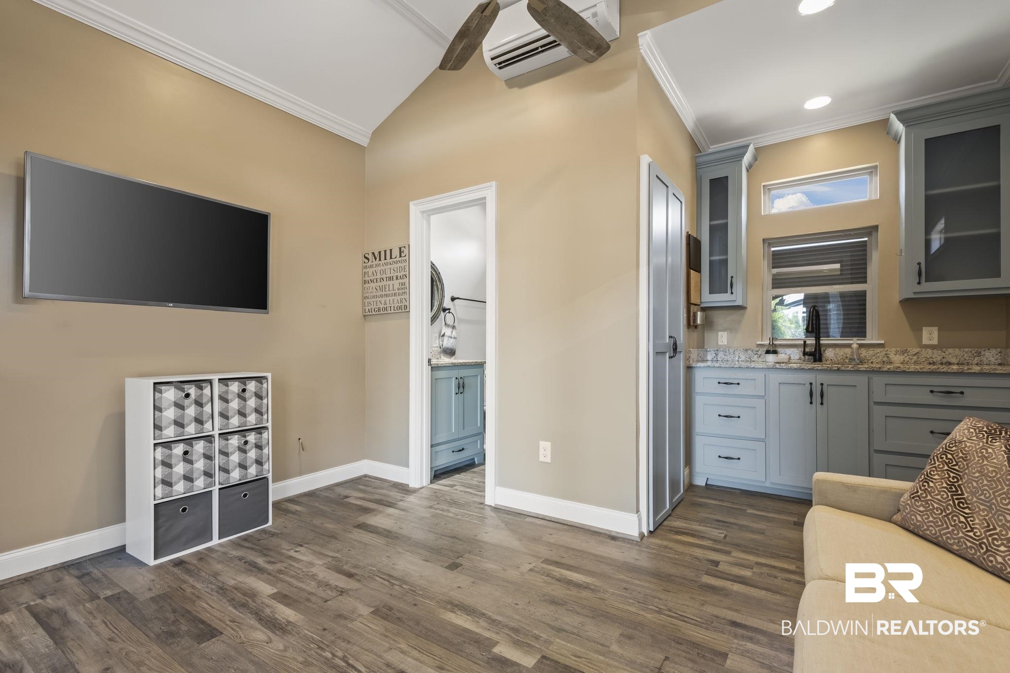 212 Magnifico Drive Foley, AL 36535 - Photo 22 of 50 Interior space with sink, gray cabinetry, light stone countertops, a wall mounted air conditioner, and dark hardwood / wood-style flooring