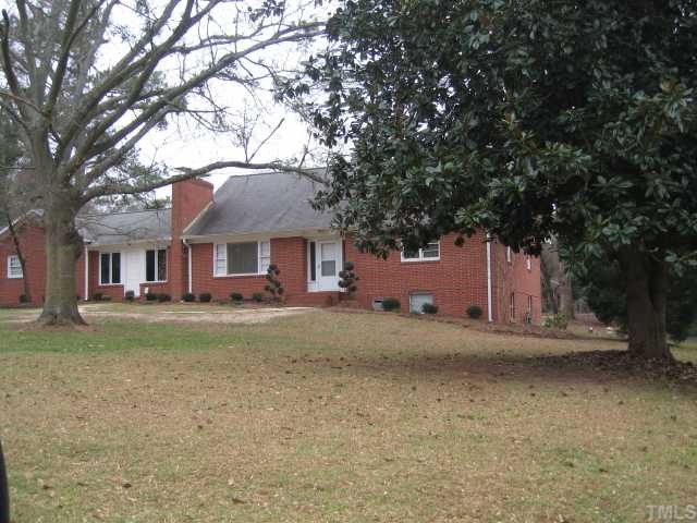 209 Lord Berkley Road Raleigh, NC 27610 - Photo 1 of 12 a front view of a house with a yard and garage