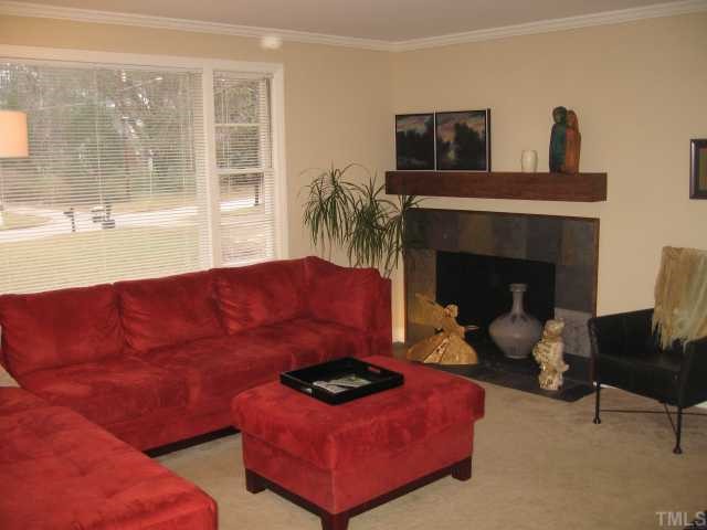 209 Lord Berkley Road Raleigh, NC 27610 - Photo 4 of 12 a living room with furniture and a fireplace