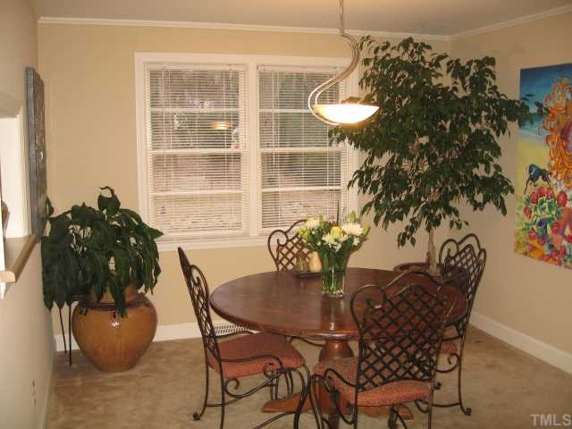 209 Lord Berkley Road Raleigh, NC 27610 - Photo 7 of 12 a view of a dining room with furniture and wooden floor
