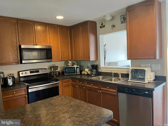 a kitchen with a sink stove and microwave