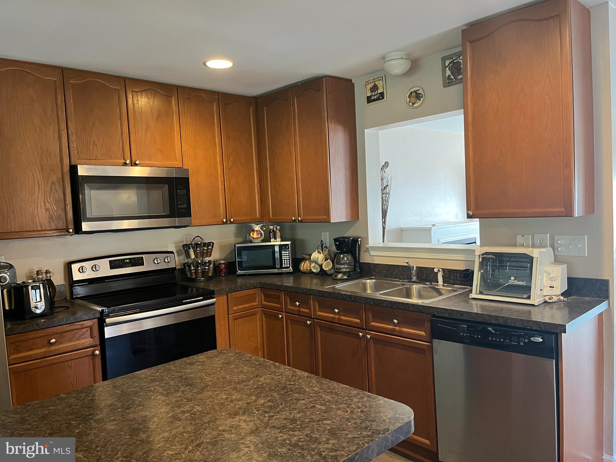 199 Rumbling Rock Road Hedgesville, WV 25427 - Photo 11 of 44 a kitchen with a sink stove and microwave
