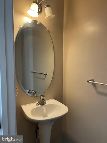 a bathroom with a sink a mirror and vanity