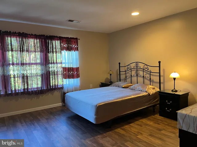 a bedroom with a bed and window