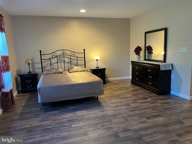 a bedroom with a bed and a dresser