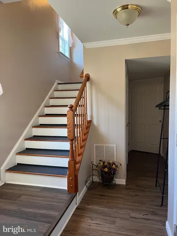 a view of entryway and hall with wooden floor