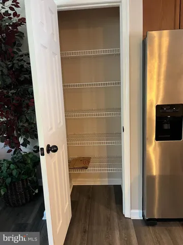 a view of walk in closet with empty room