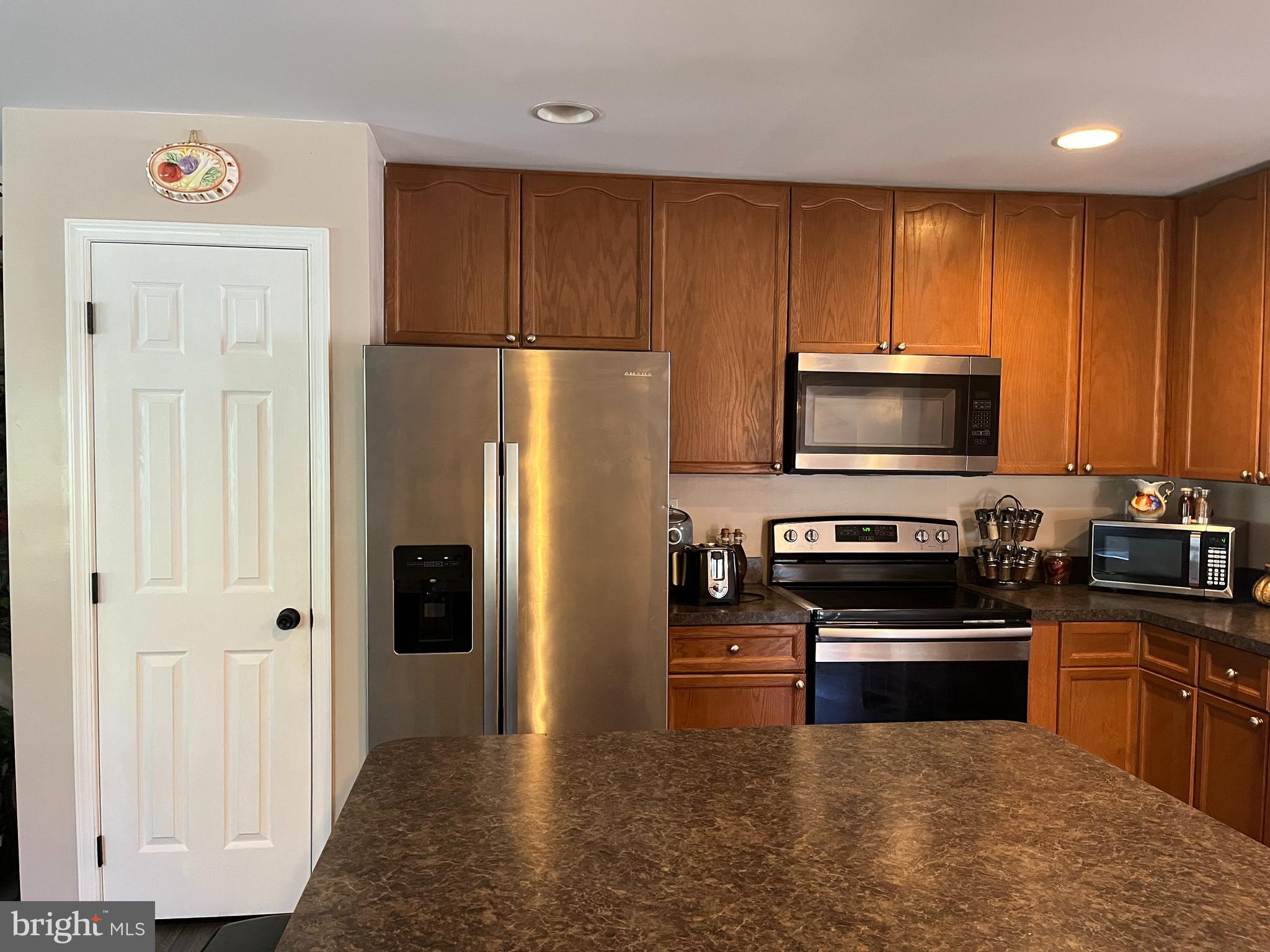 199 Rumbling Rock Road Hedgesville, WV 25427 - Photo 10 of 44 a kitchen with a refrigerator stove and microwave