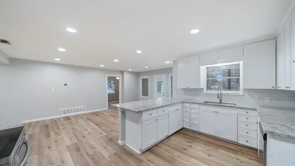 a kitchen with a sink stove and cabinets