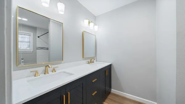 a bathroom with a double vanity sink and a mirror