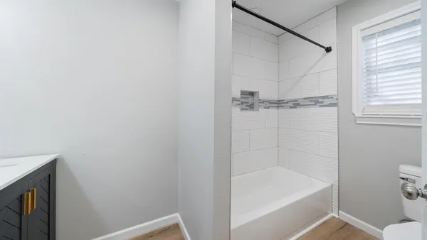 a bathroom with a bathtub and a toilet