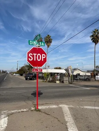 a view of a street with a car parked on the road