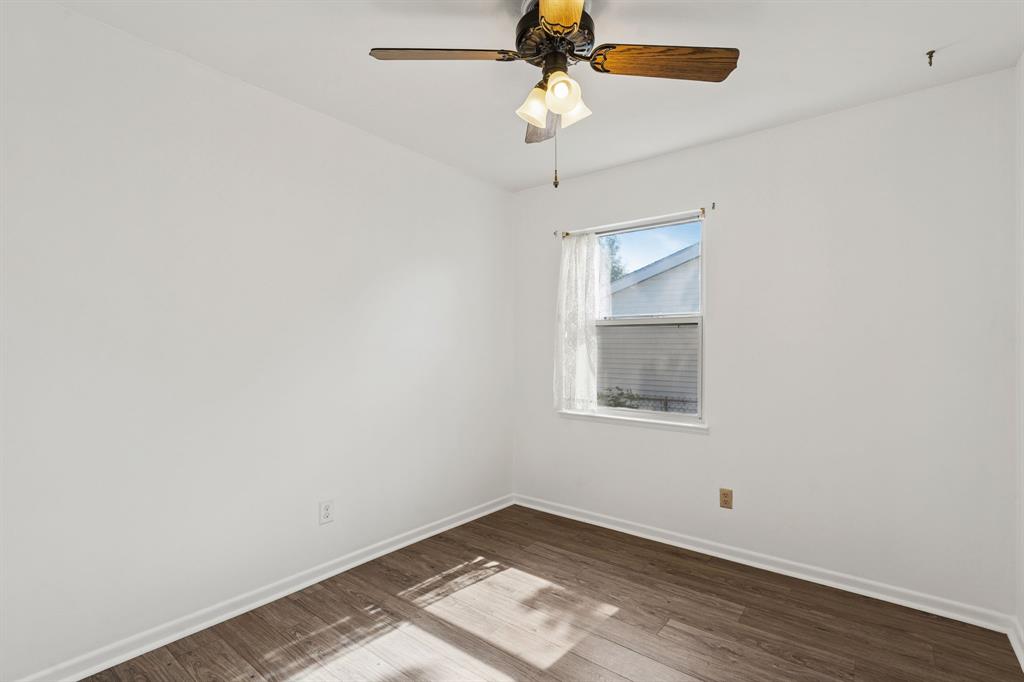 1822 Finley Road Irving, TX 75062 - Photo 27 of 38 an empty room with a window and a fan