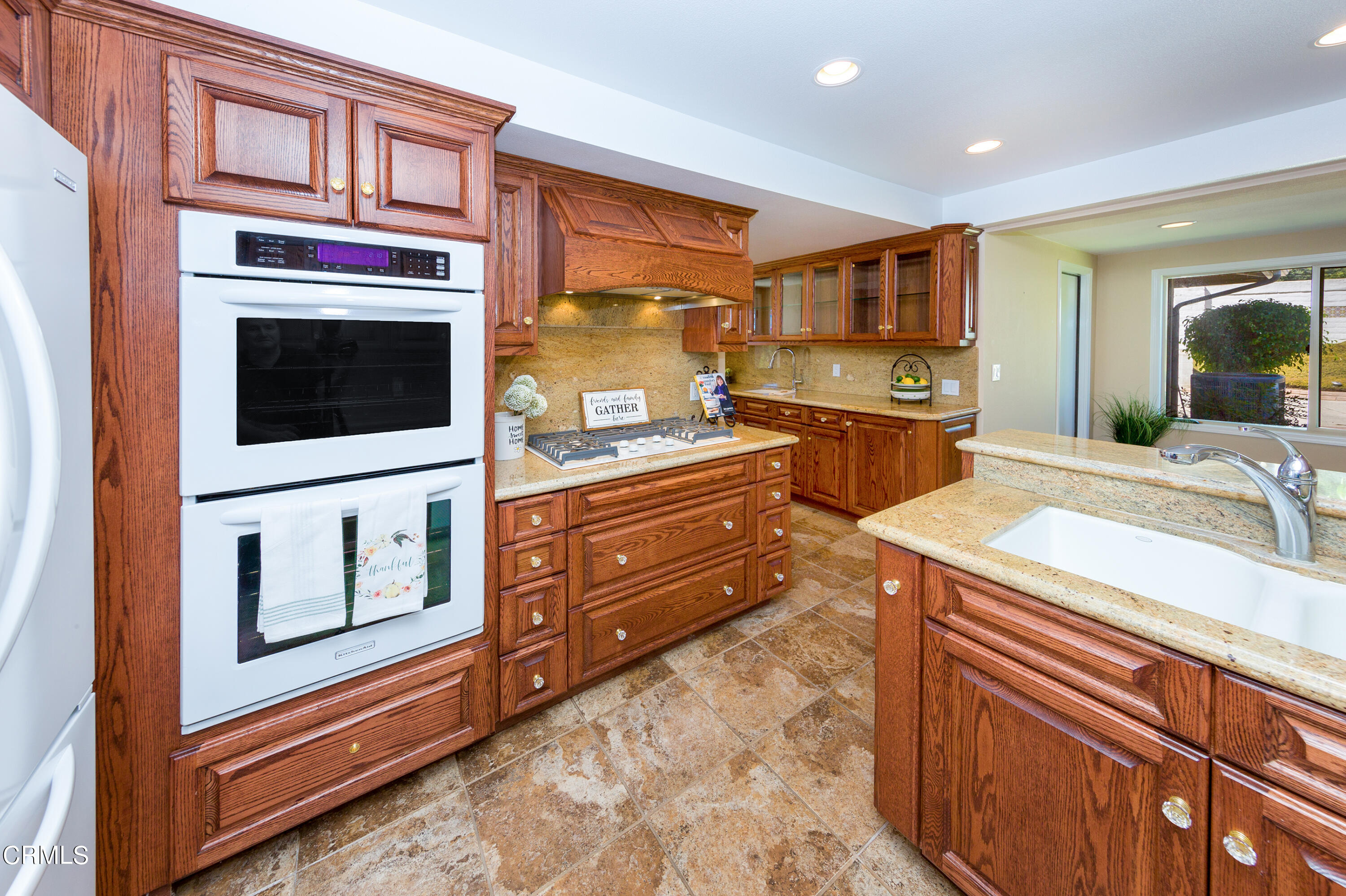 75 Vientos Road Camarillo, CA 93010 - Photo 11 of 36 a kitchen with stainless steel appliances kitchen island granite countertop a stove top oven a sink and dishwasher