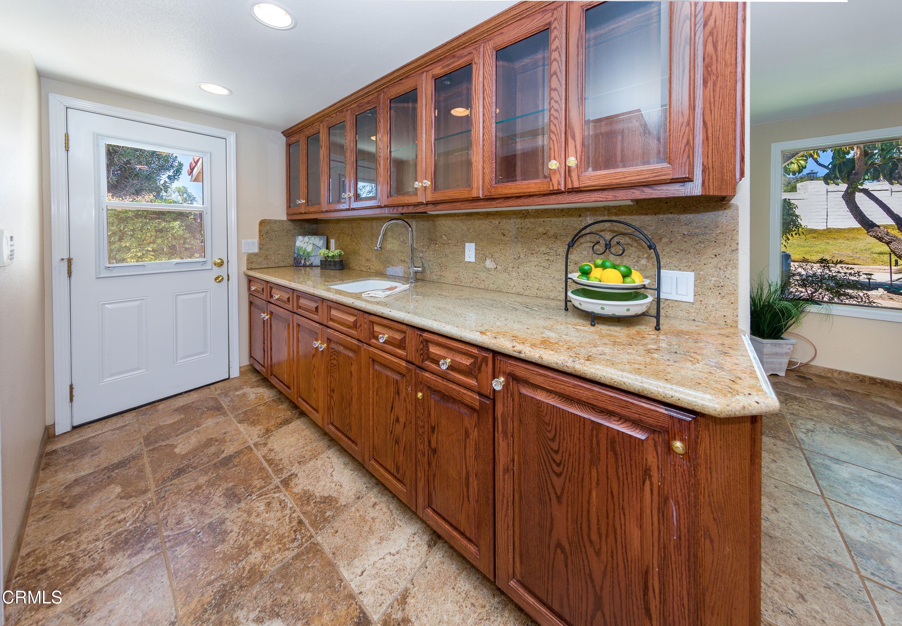 75 Vientos Road Camarillo, CA 93010 - Photo 12 of 36 a kitchen with a stove a sink and a wooden cabinets