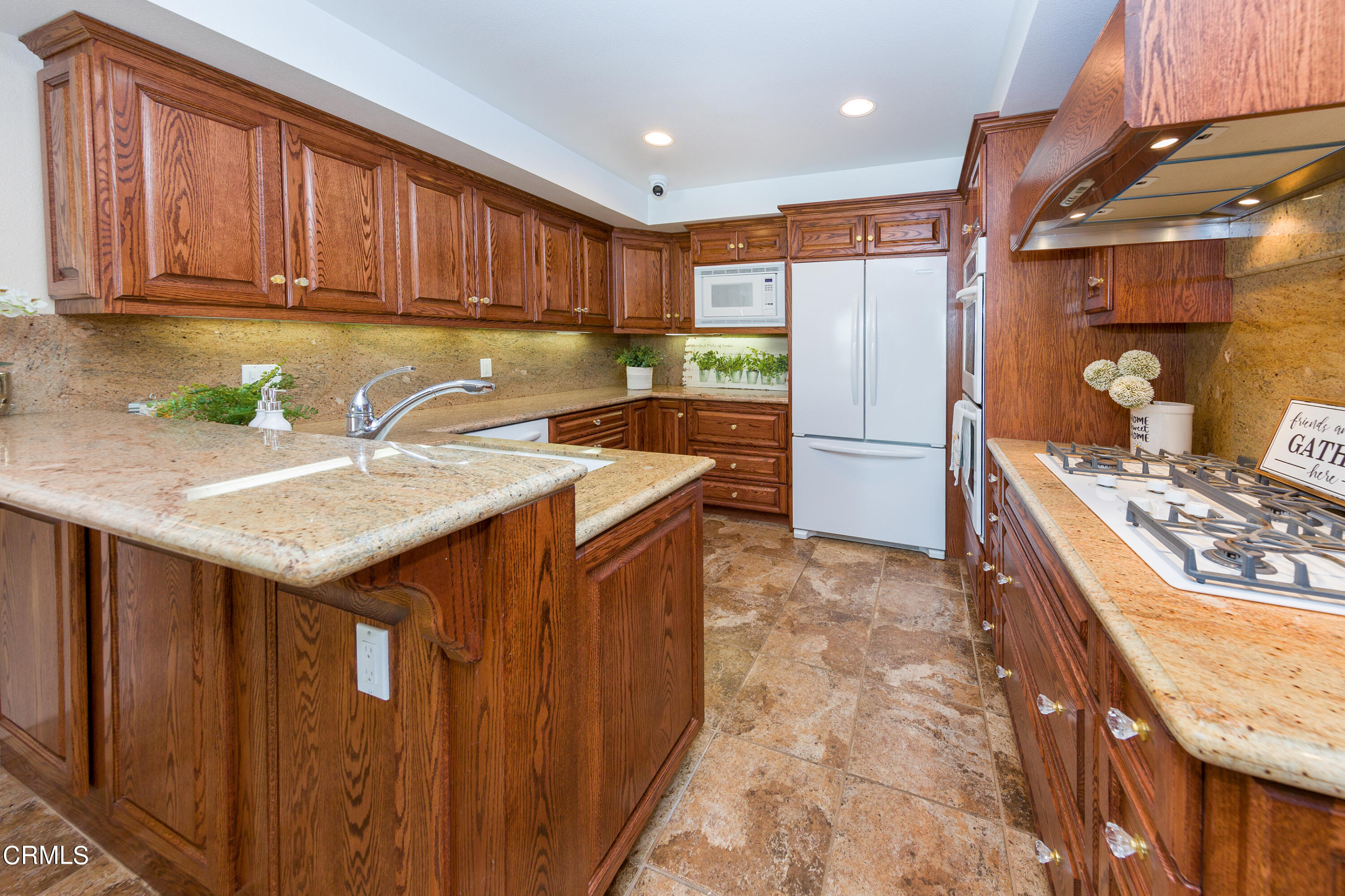 75 Vientos Road Camarillo, CA 93010 - Photo 10 of 36 a kitchen with refrigerator cabinets and a sink