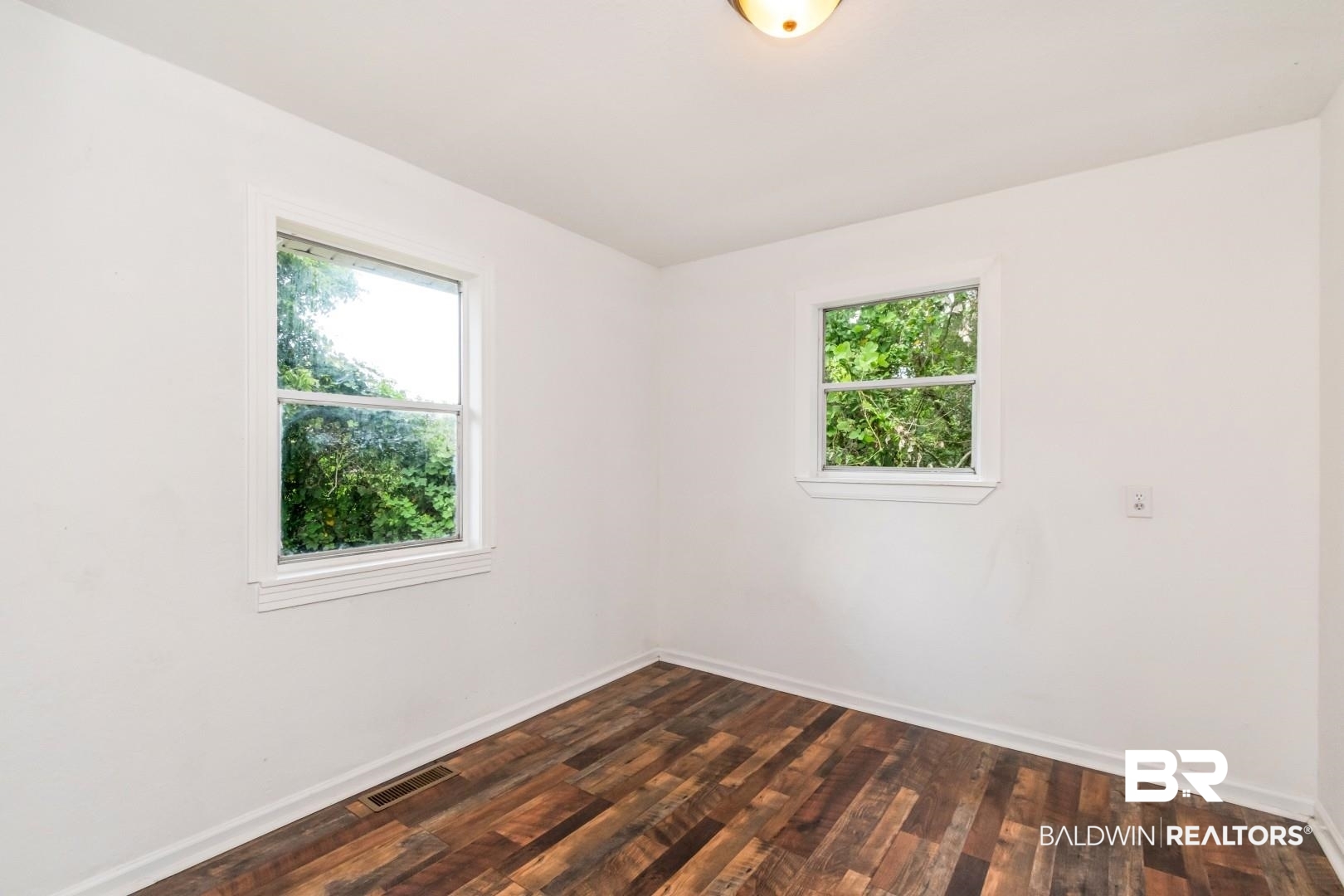 2905A McFarland Road, Unit F Mobile, AL 36695 - Photo 15 of 29 Interior room featuring wood-finish flooring and white baseboards
