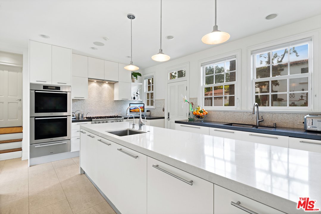 801 Devon Avenue Los Angeles, CA 90024 - Photo 13 of 25 a kitchen with stainless steel appliances granite countertop a sink a stove and a refrigerator