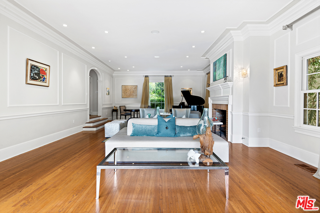 801 Devon Avenue Los Angeles, CA 90024 - Photo 7 of 25 a living room with furniture a wooden floor and a large window