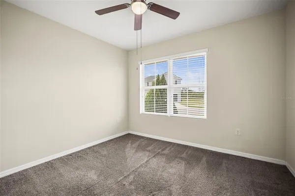 a bedroom with a bed and a potted plant