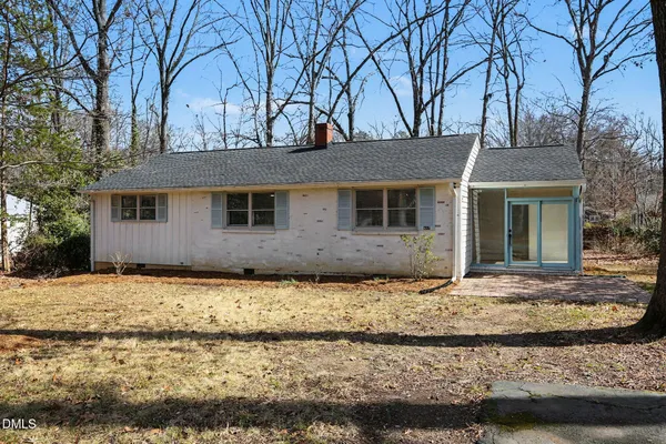 a house that has a tree in front of it