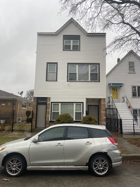 a view of a car parked in front of a house