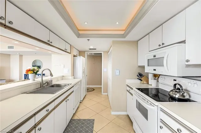 a kitchen with stainless steel appliances a sink stove and cabinets