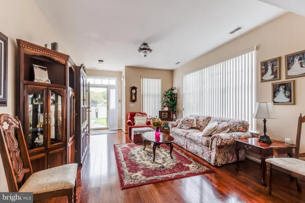 a living room with furniture fireplace and a window