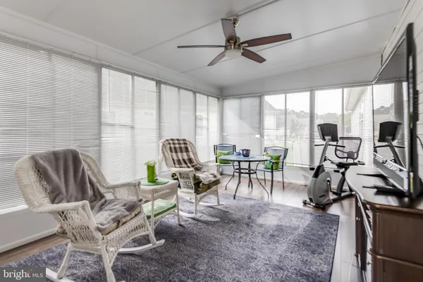 a living room with furniture a floor to ceiling windows and a table