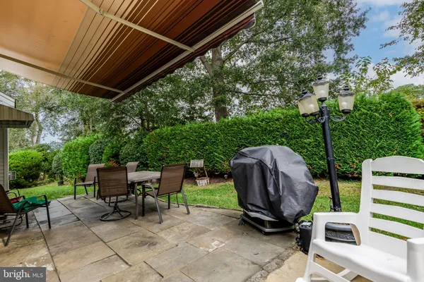 a view of backyard with outdoor seating and trees