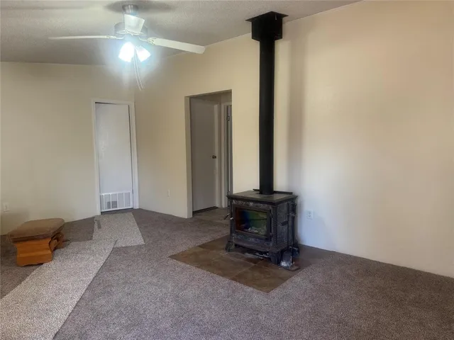 a living room with furniture a flat screen tv and a potted plant