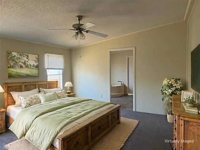 an empty room with a chandelier fan and windows