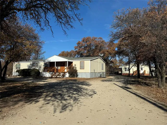 a front view of a house with yard covered in snow