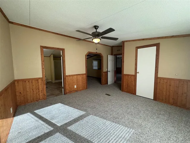 a living room with furniture and a ceiling fan