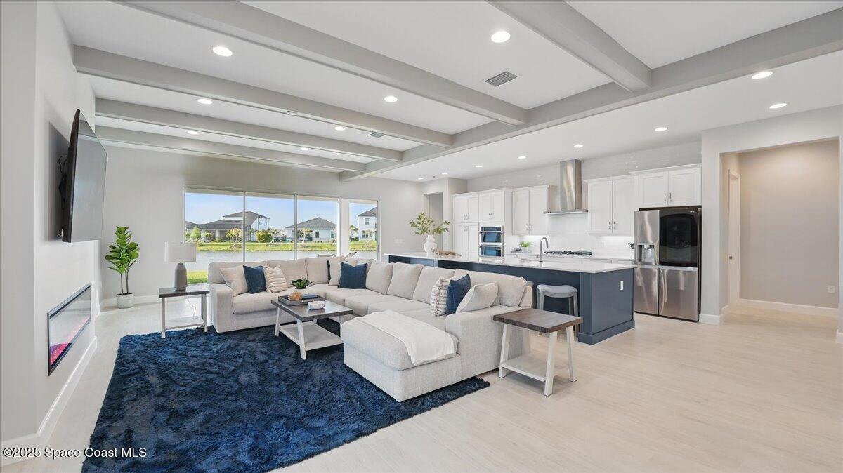 8348 Gullen Drive Melbourne, FL 32940 - Photo 13 of 58 a living room with lots of furniture and kitchen view