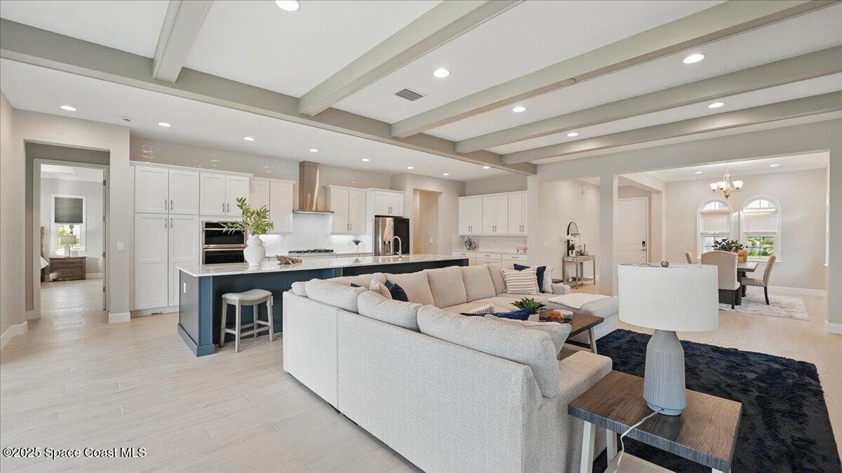 8348 Gullen Drive Melbourne, FL 32940 - Photo 14 of 58 a living room filled with furniture and kitchen view