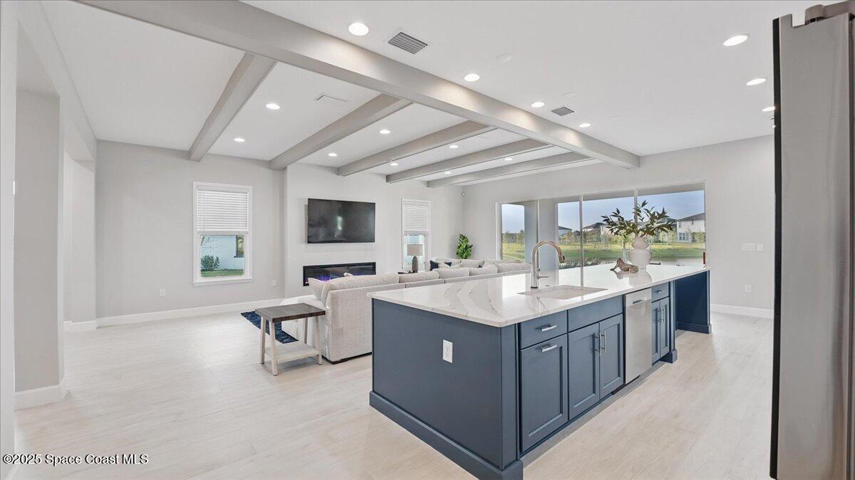 8348 Gullen Drive Melbourne, FL 32940 - Photo 20 of 58 a kitchen with stainless steel appliances granite countertop a lot of counter top space