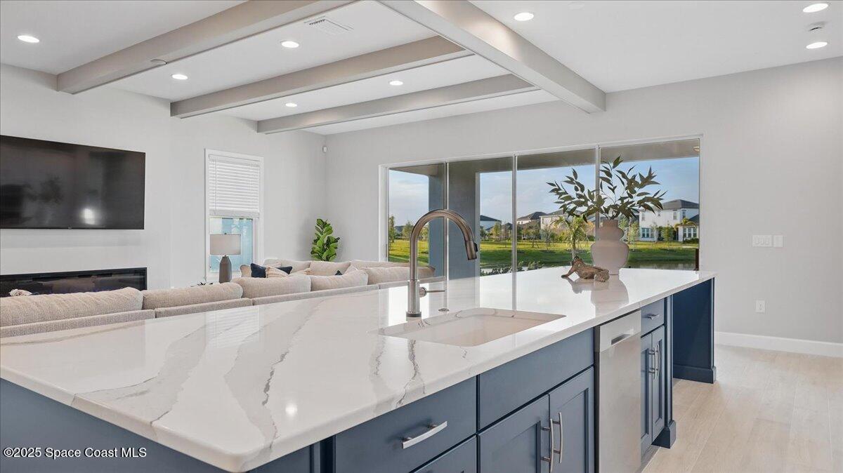 8348 Gullen Drive Melbourne, FL 32940 - Photo 21 of 58 a kitchen with stainless steel appliances a sink and a large mirror