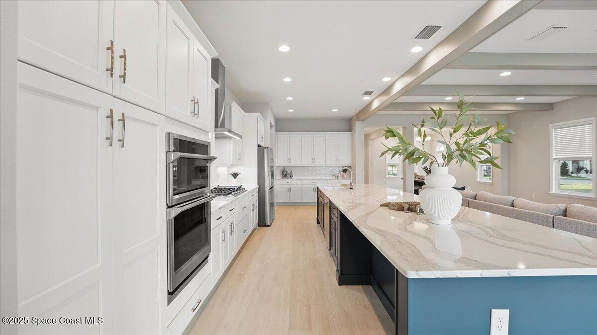 8348 Gullen Drive Melbourne, FL 32940 - Photo 24 of 58 a kitchen with stainless steel appliances granite countertop a sink a stove and a refrigerator