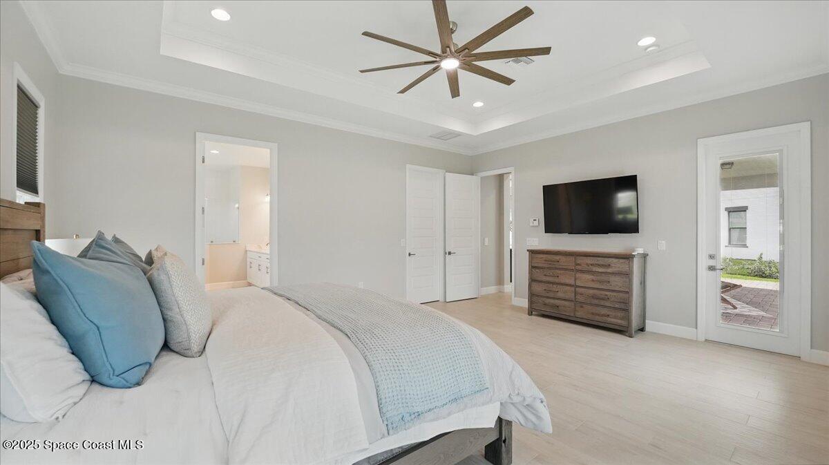 8348 Gullen Drive Melbourne, FL 32940 - Photo 27 of 58 a bedroom with a bed and a flat screen tv